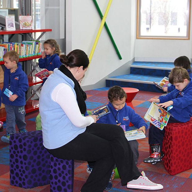 Photo of children reading book